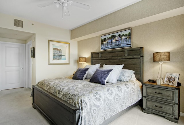 bedroom with ceiling fan and light colored carpet