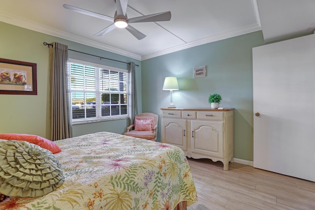 bedroom featuring ceiling fan, ornamental molding, and light hardwood / wood-style flooring