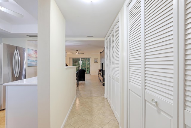 hall with light tile patterned floors