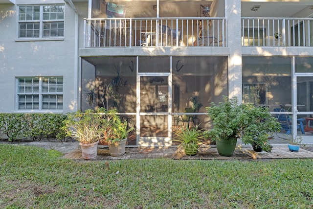 view of home's exterior with a sunroom