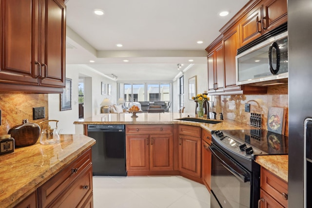 kitchen with backsplash, light stone counters, sink, and black appliances