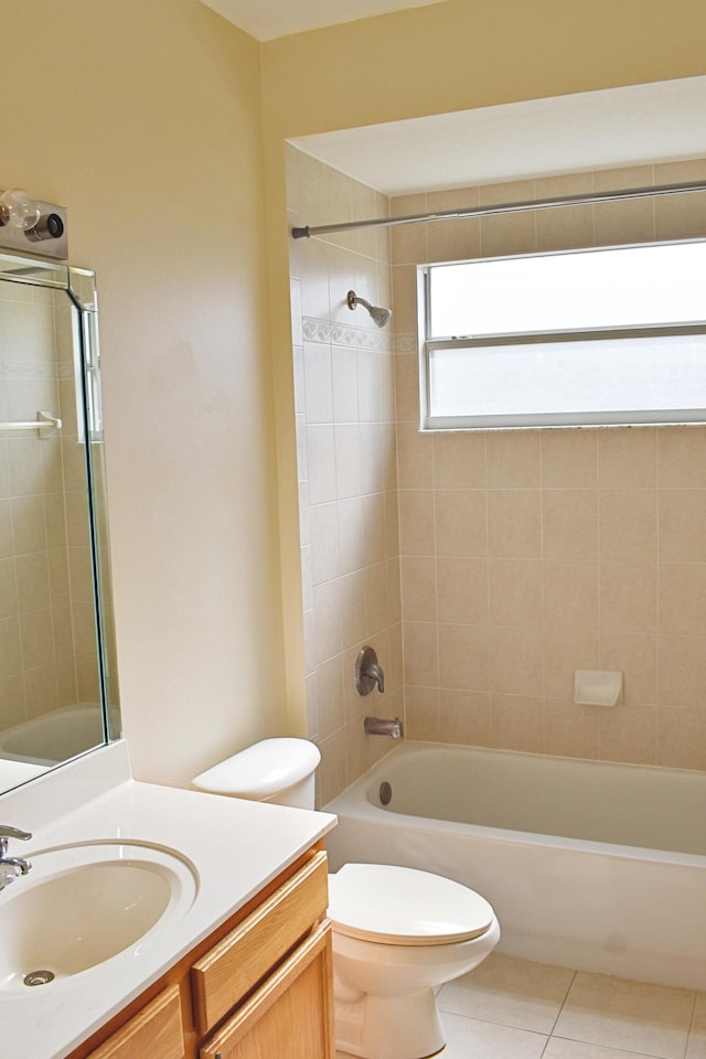 full bathroom with tile patterned floors, toilet, vanity, and tiled shower / bath