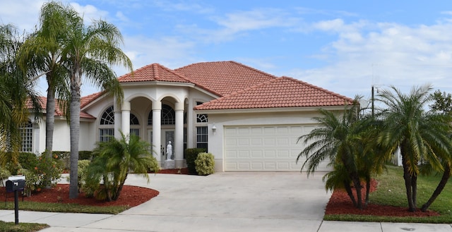 mediterranean / spanish house featuring a garage