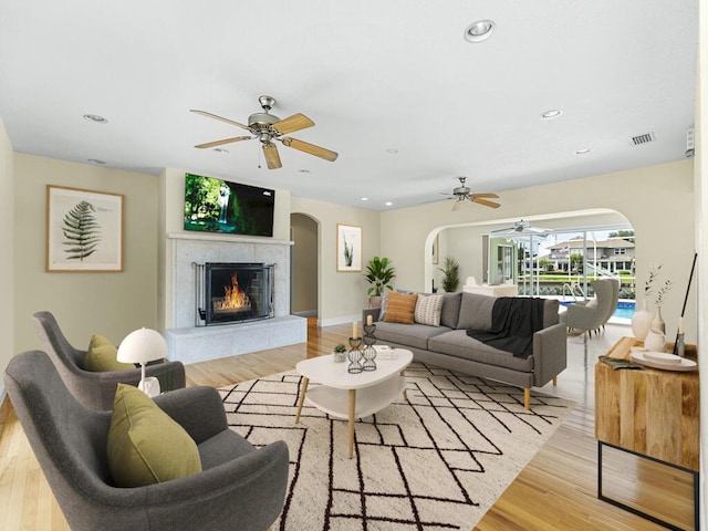 living room with ceiling fan and light wood-type flooring