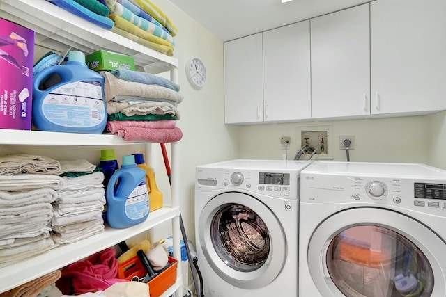 laundry room featuring cabinets and separate washer and dryer