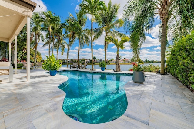 view of swimming pool featuring a water view and a patio area