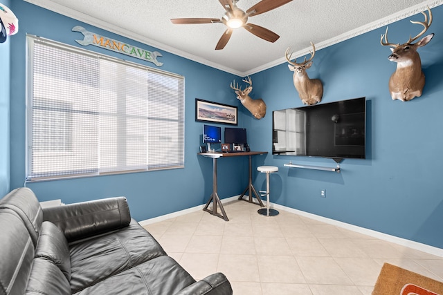 tiled living room featuring ceiling fan, a textured ceiling, and ornamental molding