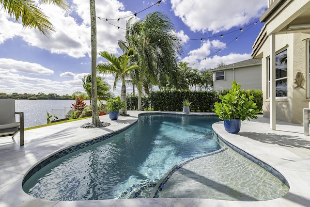 view of swimming pool featuring a patio area and a water view