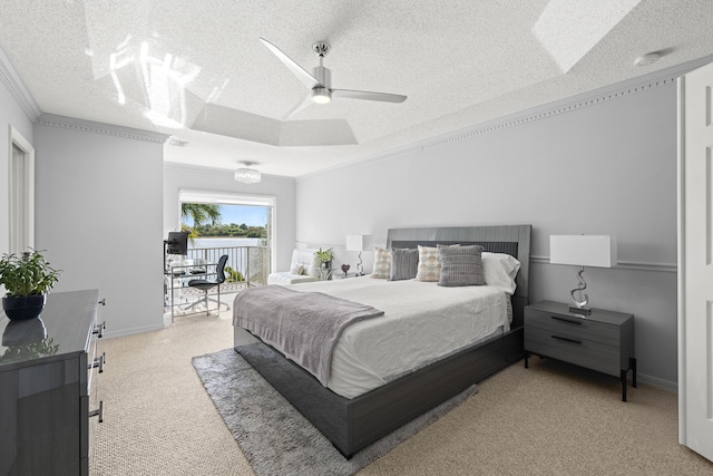 carpeted bedroom with ceiling fan, crown molding, a textured ceiling, and a tray ceiling