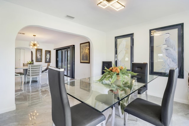 dining space with a chandelier