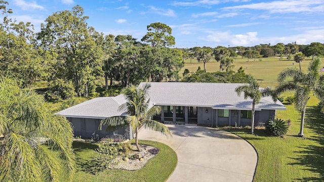 ranch-style home featuring a front yard and a carport