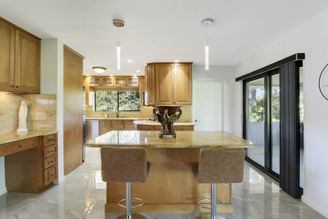 kitchen featuring sink, a healthy amount of sunlight, and decorative light fixtures