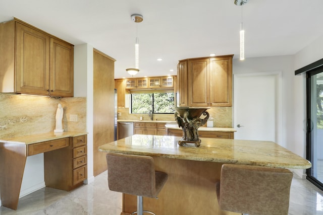 kitchen featuring decorative backsplash, sink, and hanging light fixtures