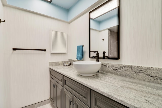 bathroom with tile patterned flooring and vanity