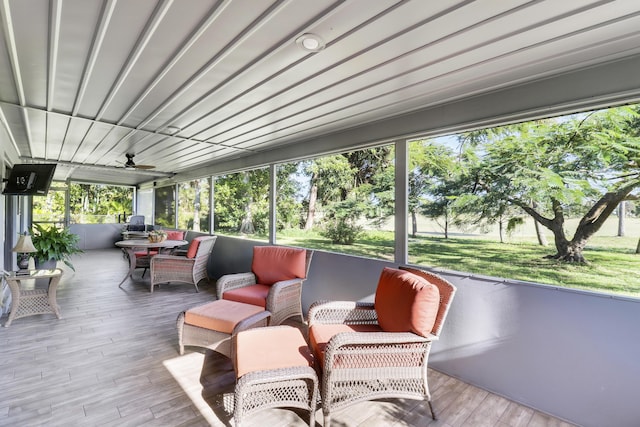 sunroom featuring ceiling fan and a healthy amount of sunlight