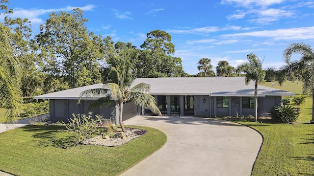 ranch-style home featuring a garage and a front yard