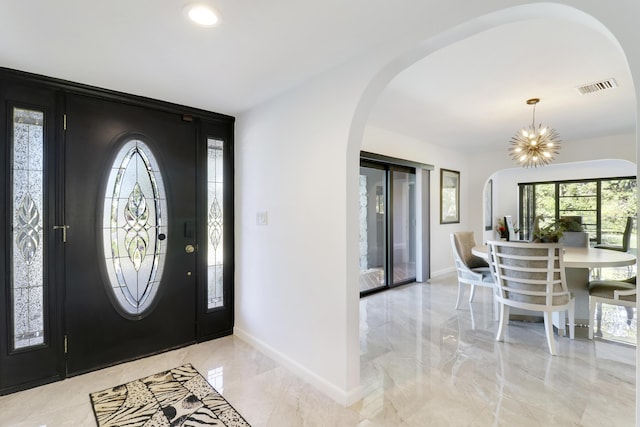 foyer with an inviting chandelier