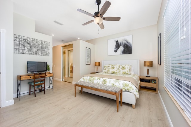 bedroom with light hardwood / wood-style floors and ceiling fan