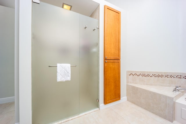 bathroom with shower with separate bathtub and tile patterned floors