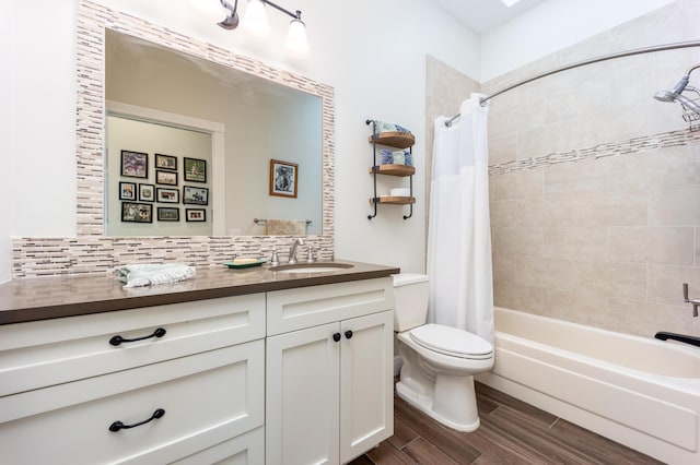 full bathroom featuring backsplash, vanity, shower / bathtub combination with curtain, and toilet