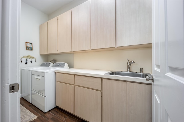 laundry area with separate washer and dryer, sink, and cabinets