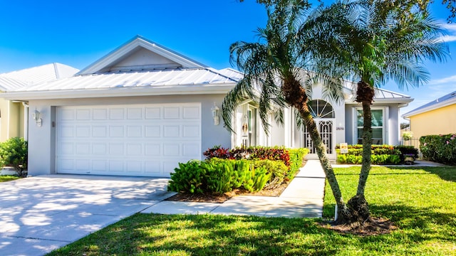 view of front of property featuring a front yard and a garage