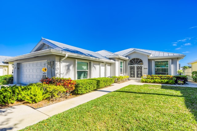 ranch-style home with french doors, a front lawn, and a garage