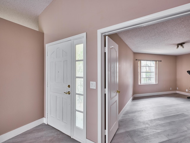 entryway featuring hardwood / wood-style floors and a textured ceiling