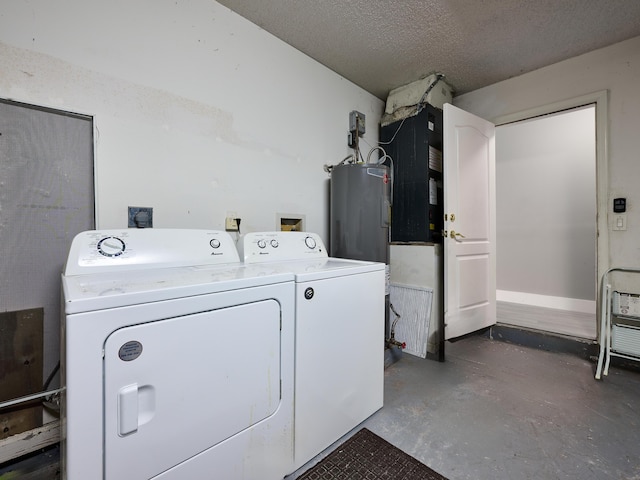 clothes washing area with washing machine and dryer, water heater, and a textured ceiling