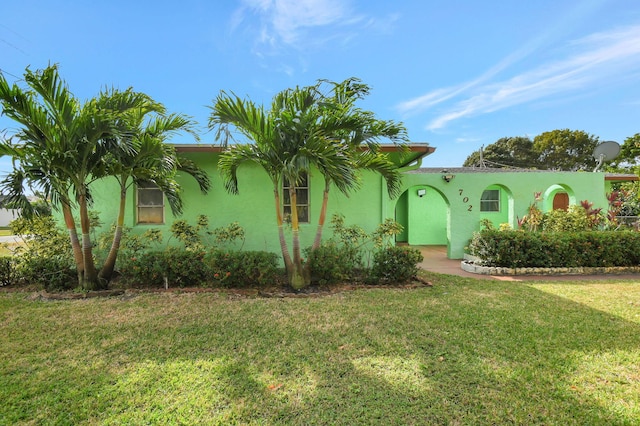 mediterranean / spanish house with a front yard