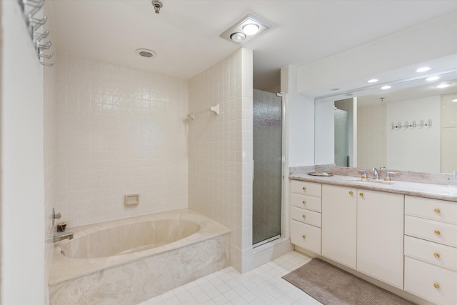 bathroom featuring shower with separate bathtub, vanity, and tile patterned floors