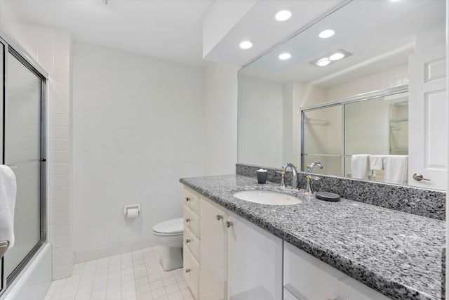 full bathroom featuring tile patterned flooring, vanity, toilet, and shower / bath combination with glass door