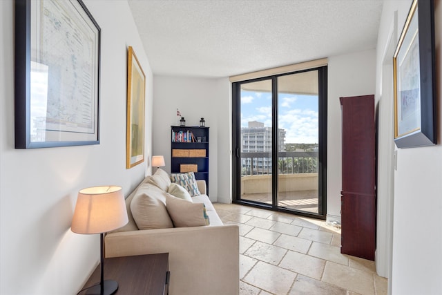 living room featuring floor to ceiling windows and a textured ceiling