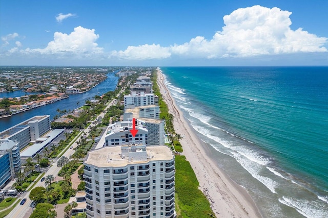 drone / aerial view featuring a water view and a beach view