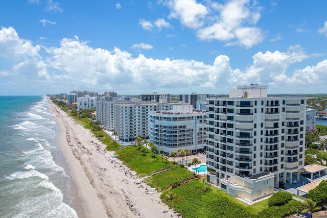 bird's eye view featuring a water view and a beach view