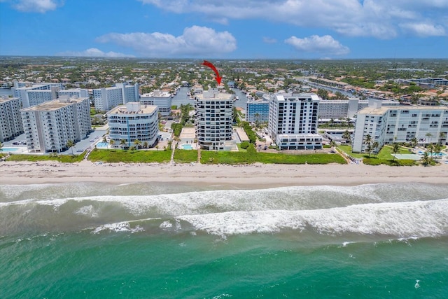 birds eye view of property with a view of the beach and a water view