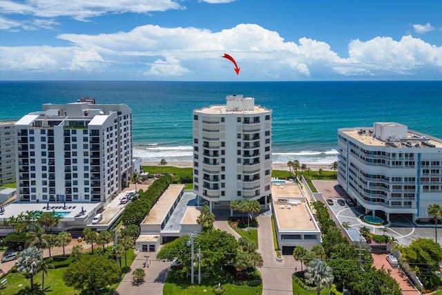 birds eye view of property featuring a water view and a view of the beach