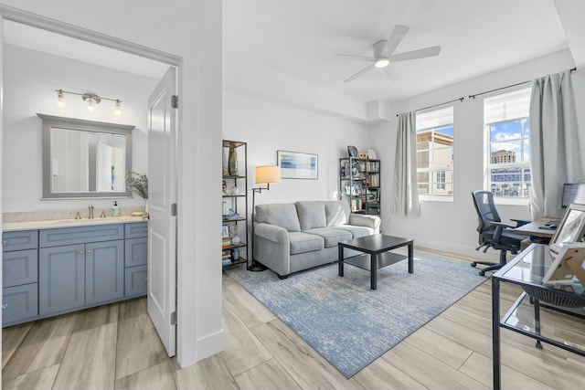 office with ceiling fan, sink, and light hardwood / wood-style floors