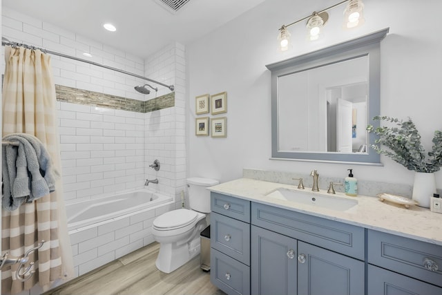 full bathroom with wood-type flooring, vanity, toilet, and shower / bath combo with shower curtain