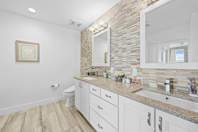 bathroom with decorative backsplash, vanity, hardwood / wood-style flooring, and toilet