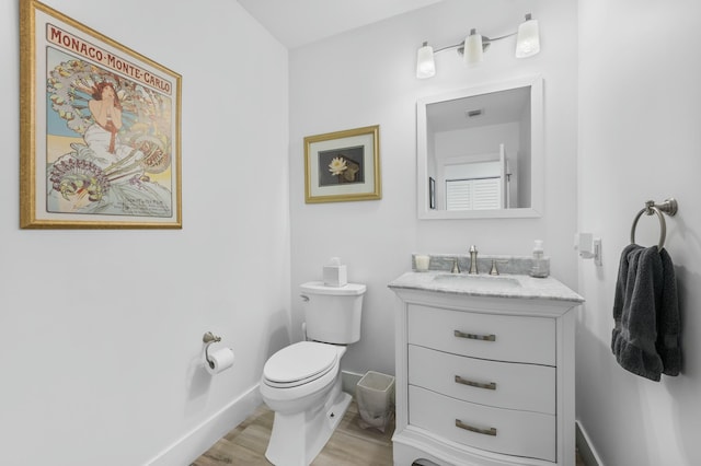 bathroom featuring hardwood / wood-style floors, vanity, and toilet