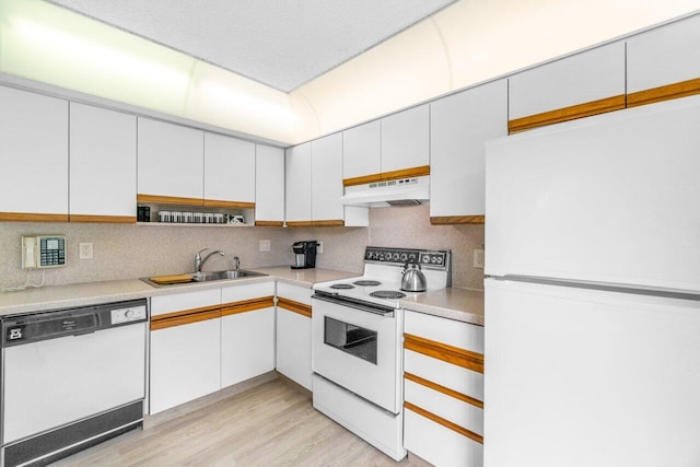 kitchen featuring sink, white cabinets, and white appliances