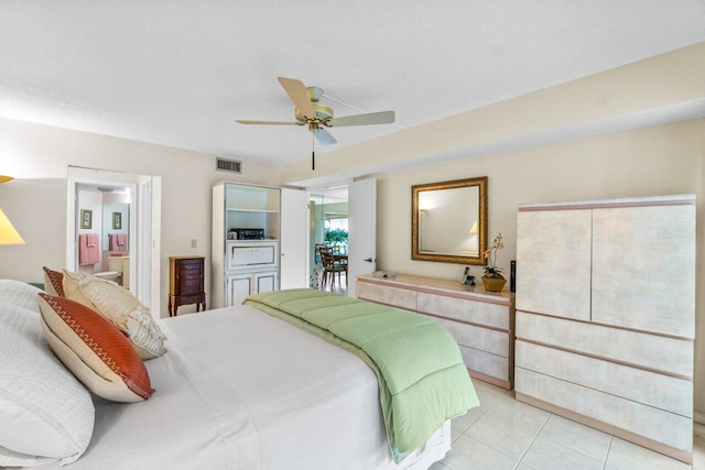 tiled bedroom featuring ceiling fan and a textured ceiling