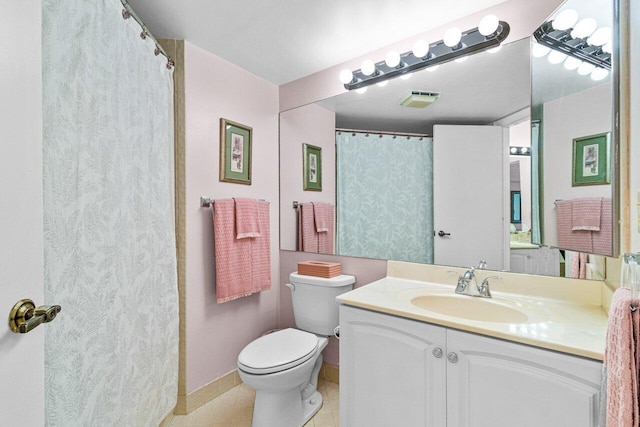 bathroom with tile patterned floors, vanity, and toilet