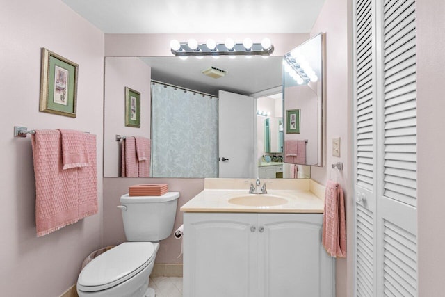 bathroom featuring tile patterned floors, vanity, and toilet