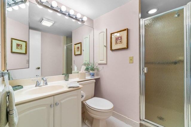 bathroom with tile patterned flooring, vanity, toilet, and an enclosed shower