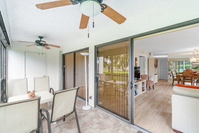 sunroom with ceiling fan