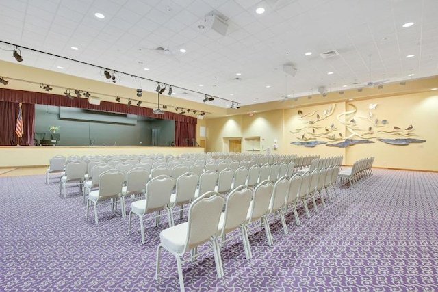 interior space featuring carpet floors and rail lighting