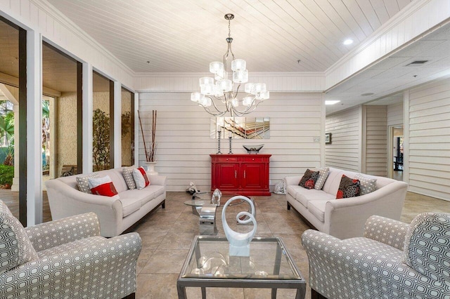 living room with a chandelier, wooden ceiling, crown molding, and wooden walls