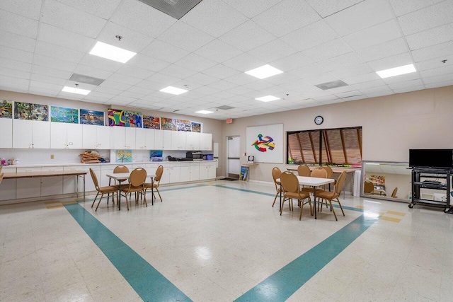 interior space with a paneled ceiling